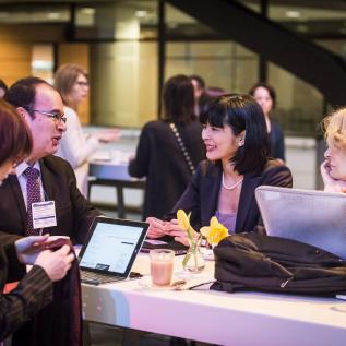 People speaking around a table at an event